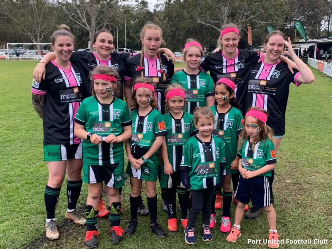 Group photo in matching custom rash guards made by leading sportswear manufacturer